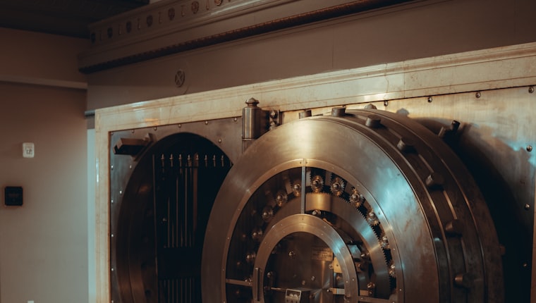 The brass door of a bank vault, standing open