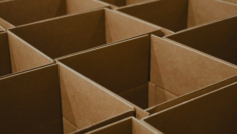 Rows of empty cardboard box compartments seen from above